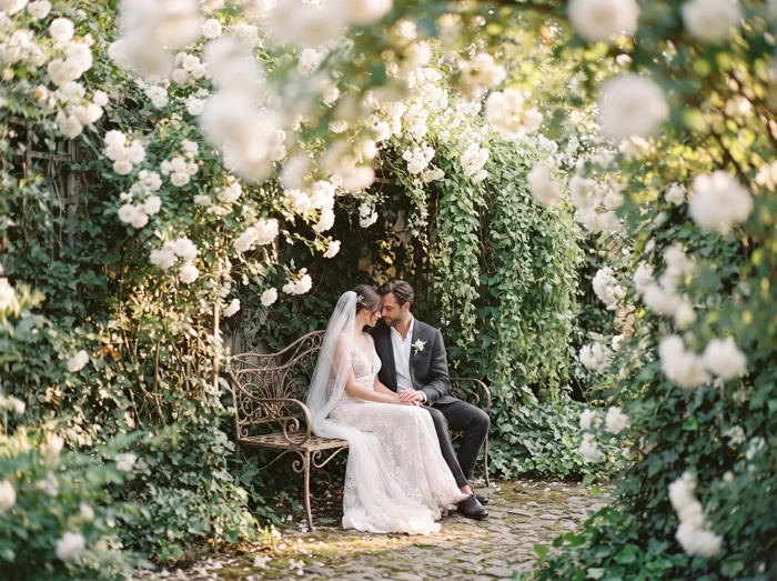 A couple celebrating in a flower-filled garden